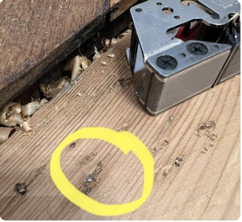 Hidden nail in a wooden board on a job site